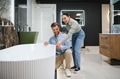 Couple exploring modern bathroom fixtures in store - PhotoDune Item for Sale