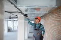 Engineer inspecting ventilation system in building under construction - PhotoDune Item for Sale