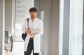 Arab medical student carrying books in university hallway - PhotoDune Item for Sale