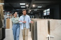 Couple choosing ceramic tiles in hardware store for bathroom renovation - PhotoDune Item for Sale