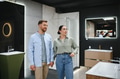 Couple holding hands choosing bathroom fixtures in showroom - PhotoDune Item for Sale