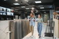 Family choosing ceramic tiles in a store with samples on display - PhotoDune Item for Sale