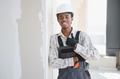 Smiling african american construction worker gesturing thumbs up in building under construction - PhotoDune Item for Sale