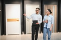 Shop assistant showing doors to customer in hardware store - PhotoDune Item for Sale