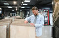 Customer choosing ceramic tiles in hardware store - PhotoDune Item for Sale