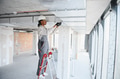 Construction worker installing ventilation system on a ladder - PhotoDune Item for Sale