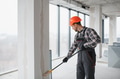 Construction worker painting walls with roller in building renovation - PhotoDune Item for Sale