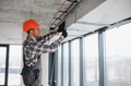 Construction worker installing ventilation system in building - PhotoDune Item for Sale