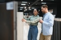 Couple choosing ceramic tiles in a store for home renovation - PhotoDune Item for Sale