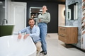 Happy couple choosing bathtub in bathroom furniture store - PhotoDune Item for Sale