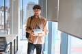University student carrying books in modern building - PhotoDune Item for Sale