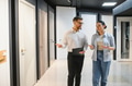 Shop assistant showing doors to customer in hardware store - PhotoDune Item for Sale