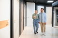 Couple holding hands choosing interior doors in hardware store - PhotoDune Item for Sale