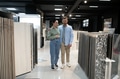 Couple exploring ceramic tile options in store - PhotoDune Item for Sale