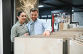 Couple choosing ceramic tiles in hardware store for bathroom renovation - PhotoDune Item for Sale