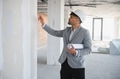 Arab architect inspecting construction site holding blueprints - PhotoDune Item for Sale