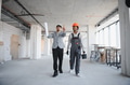 Architect showing plans to builder during construction inspection - PhotoDune Item for Sale
