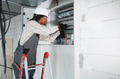 Electrician working on electrical panel in building under construction - PhotoDune Item for Sale