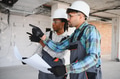 Architects discussing blueprint on construction site - PhotoDune Item for Sale