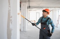 Arab Construction worker painting walls with roller in building under construction - PhotoDune Item for Sale
