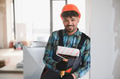 Smiling arab painter holding paint roller in construction site - PhotoDune Item for Sale