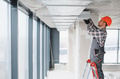 Builder installing ventilation system in modern office building - PhotoDune Item for Sale