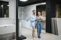 Couple choosing bathroom fixtures in a plumbing store - PhotoDune Item for Sale