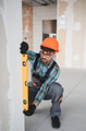 Construction worker checking wall straightness with spirit level - PhotoDune Item for Sale