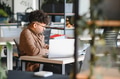 Focused arab university student studying with laptop in modern library - PhotoDune Item for Sale