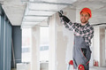 Construction worker installing ventilation system in building - PhotoDune Item for Sale