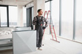 Construction worker installing ventilation system in building - PhotoDune Item for Sale