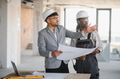 Architect showing blueprint to builder during construction inspection - PhotoDune Item for Sale