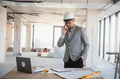Arab architect managing construction project, talking on phone at building site - PhotoDune Item for Sale
