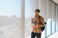 Arab student walking in university corridor holding books - PhotoDune Item for Sale