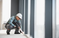 Construction worker applying sealant to window frame - PhotoDune Item for Sale