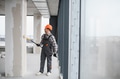 Construction worker painting walls in building under construction - PhotoDune Item for Sale