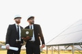 Engineers using laptop analyzing solar panel farm for sustainable energy production - PhotoDune Item for Sale
