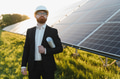 Investor inspecting solar panel farm with blueprint at sunset - PhotoDune Item for Sale