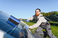 Technician cleaning solar panel with brush for green energy production - PhotoDune Item for Sale