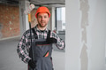 Construction worker holding paint roller and pointing at himself - PhotoDune Item for Sale