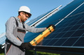 Skilled technician installing solar panels with precision - PhotoDune Item for Sale