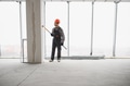 Construction worker painting walls in a building under construction - PhotoDune Item for Sale