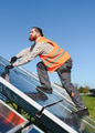 Worker installing solar panels in a solar farm - PhotoDune Item for Sale