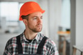 Construction worker wearing hardhat inspecting building under construction - PhotoDune Item for Sale