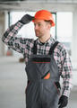 Construction worker adjusting helmet in building under construction - PhotoDune Item for Sale