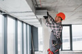Construction worker installing ventilation system in building - PhotoDune Item for Sale