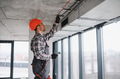 Construction worker installing ventilation system in building - PhotoDune Item for Sale