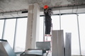 Construction worker installing ventilation system on a ladder in building under construction - PhotoDune Item for Sale