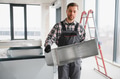 Hvac technician installing ventilation system in building under construction - PhotoDune Item for Sale
