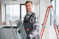 Hvac technician installing ventilation system in building under construction - PhotoDune Item for Sale